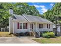 Close up of a charming single-story home with red shutters and a cozy front porch at 4533 Whistling Way, Raleigh, NC 27616