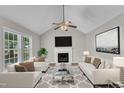 Inviting living room featuring vaulted ceilings, a cozy fireplace, and lots of natural light at 4533 Whistling Way, Raleigh, NC 27616
