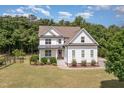 Stunning aerial view of this two-story white farmhouse-style home showcasing lush landscaping and a spacious lawn at 5180 Old Powell Rd, Holly Springs, NC 27540