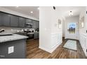 Welcoming view of the home's entryway, with sightline to the kitchen, featuring wood-look flooring and wainscoting at 55 E American Marigold Dr # 36, Benson, NC 27504