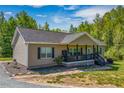 Attractive single-story home boasting a cozy front porch, perfect for relaxation at 5912 Mt Zion Rd, Snow Camp, NC 27349