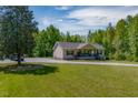 Charming one-story home features a welcoming front porch with lovely green lawn at 5912 Mt Zion Rd, Snow Camp, NC 27349
