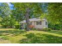 Beautiful home with a lush green lawn and mature trees providing ample shade at 701 Veterans Dr, Elon, NC 27244