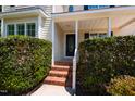 Front porch with brick steps and black door in a well-maintained home at 716 Lakeview Ave, Wake Forest, NC 27587