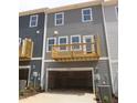 Townhome with a spacious garage, rear wooden deck, and attractive exterior in a desirable neighborhood at 805 Hyperion Aly, Wake Forest, NC 27587