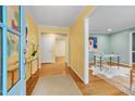 Inviting foyer with hardwood floors, bright yellow walls, and access to a study area at 823 Churchill Dr, Chapel Hill, NC 27517
