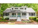 Beautifully renovated home showcasing a bright blue door, black shutters, and a brick pathway leading to the entrance at 823 Churchill Dr, Chapel Hill, NC 27517