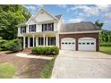 Traditional two-story house with black shutters and an attached two-car garage at 84 Sycamore Lake Rd, Siler City, NC 27344