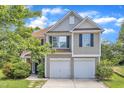 Charming two-story home with a two car garage and manicured lawn at 10 Marsh Landing Ct, Durham, NC 27703
