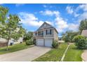 Charming two-story home with a two car garage, manicured lawn, and view of the lake at 10 Marsh Landing Ct, Durham, NC 27703