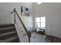 Bright foyer featuring wood floors, stairs with white risers, and natural light from a window at 1033 Talisker Way # 16, Burlington, NC 27215