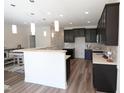 Modern kitchen with dark cabinetry, white countertops, pendant lighting, and stainless steel appliances at 1033 Talisker Way # 16, Burlington, NC 27215