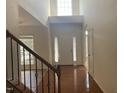 Bright foyer with high ceilings, hardwood floors, and staircase with wood and iron railing at 104 Elmsford St, Durham, NC 27703