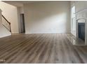 Open living space with a modern fireplace, light-colored walls, and vinyl plank flooring at 104 Elmsford St, Durham, NC 27703
