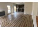 Spacious living room with fireplace and an open floor plan that leads into the kitchen at 104 Elmsford St, Durham, NC 27703