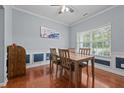 Traditional dining room with wood floors, light-blue walls, and wainscoting at 1301 Torrey Pines Ct, Mebane, NC 27302