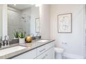 Modern bathroom featuring double sinks, gray counters, and a large shower at 1482 Hasse Ave, Apex, NC 27502
