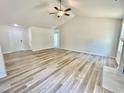 Spacious living room features vaulted ceilings, wood-look flooring, and a cozy fireplace at 158 Sourgum Ct, Zebulon, NC 27597