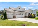 Lovely home with an attached three car garage and well-manicured lawn at 164 Wilson Farm Ln, Clayton, NC 27527