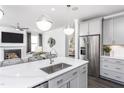 Stylish kitchen featuring stainless steel appliances, an island with a sink, and sleek gray cabinetry at 1825 Angelonia Way, Fuquay Varina, NC 27526