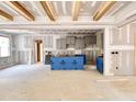 Open-concept kitchen and living space with modern gray cabinets, ample natural light, and open sight lines at 188 Buckaroo Dr, Louisburg, NC 27549