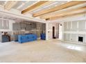 Spacious kitchen and living area featuring wooden beams, gray cabinets, and an open-concept design at 188 Buckaroo Dr, Louisburg, NC 27549