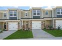 New construction townhouse with brick facade and siding, an attached garage, and a well-manicured front lawn at 1905 Hinesley Dr, Durham, NC 27703