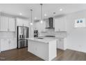 Modern kitchen featuring an island, stainless steel appliances, and ample cabinet space at 2021 Clydner Dr, Apex, NC 27523