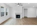 Bright living room with hardwood floors, a fireplace, and large windows for natural light at 2021 Clydner Dr, Apex, NC 27523