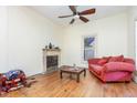 Cozy living room with a fireplace, a comfortable couch, and natural light from the windows at 206 N State St, Raleigh, NC 27601