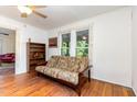 Bright room with a futon, wood bookcase and two windows with a view at 206 N State St, Raleigh, NC 27601