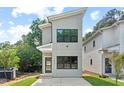 Stylish two-story home with a gray exterior, modern design, and neat landscaping in a sunny setting at 2205 Tampa Ave, Durham, NC 27705