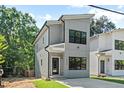 Modern two-story home featuring gray siding, black framed windows, and a welcoming front entrance at 2205 Tampa Ave, Durham, NC 27705