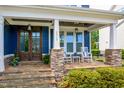 Charming front porch with stone accents, rocking chairs, and a beautifully stained wood door at 2601 Brookstone Ridge, Raleigh, NC 27613