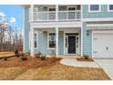 Close up view of a two-story home's front door with a black door and white columns at 3008 Dog Rose Dr # 307, Durham, NC 27703
