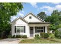 Charming home showcasing a well-manicured lawn and white siding at 303 Godwin St, Selma, NC 27576