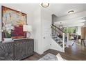 Stylish entryway featuring modern art, decorative furniture, and a staircase at 327 Augusta Pond Way # 172, Raleigh, NC 27603