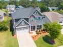 Aerial view of a two-story home with landscaped yard, double garage, and neighborhood setting at 3413 S Beaver Ln, Raleigh, NC 27604