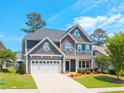 Attractive two-story home featuring a lush green lawn, double garage, and covered front entry at 3413 S Beaver Ln, Raleigh, NC 27604