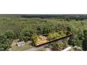 Aerial view of the property and neighborhood, showcasing a private lot surrounded by lush greenery at 3899 Warrenton Rd, Henderson, NC 27537