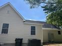 Exterior view of home showing modern siding, roof, and HVAC system at 409 S Flanner St St, Burlington, NC 27215