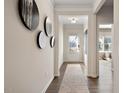 Inviting foyer with hardwood floors, decorative wall art, and a view to the front door at 48 Spirit Springs Rd, Smithfield, NC 27577