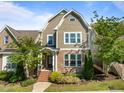 Charming two-story home with stone accents, mature landscaping, and inviting brick stairs leading to the entrance at 49 Salt Cedar Ln, Chapel Hill, NC 27516