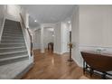 Elegant foyer with hardwood floors, wainscoting, and a staircase, setting a sophisticated tone at 49 Salt Cedar Ln, Chapel Hill, NC 27516
