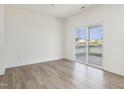 The living room features wood-look floors, neutral paint and sliding glass door at 504 Winding Creek Dr Dr, Lillington, NC 27546
