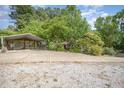 Large concrete driveway and carport in a wooded setting, providing ample parking space at 515 Poplar Dr, Raleigh, NC 27603
