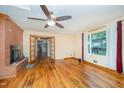 Spacious living room features hardwood floors, brick fireplace, ceiling fan and natural light at 515 Poplar Dr, Raleigh, NC 27603