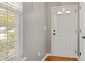 Bright foyer with hardwood floors, white door, and natural light at 524 Woodson Dr, Clayton, NC 27527