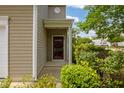 Close up of the front entry and lush greenery add to the charm of this home at 524 Woodson Dr, Clayton, NC 27527