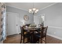 Formal dining area with hardwood floors, a chandelier, and a round table set for dining at 535 W Holding Ave, Wake Forest, NC 27587